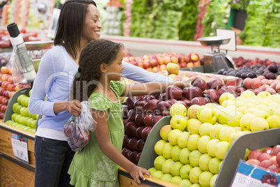 Mother and daughter in produce section