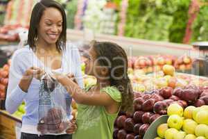 Mother and daughter in produce section