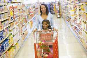 Mother and daughter shopping in supermarket