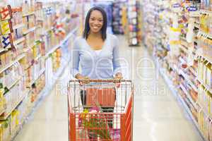 Woman pushing trolley in supermarket