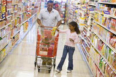 Father and daughter shopping in supermarket