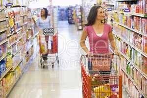 Two women shopping in supermarket