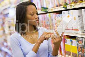 Female shopper checking food labelling