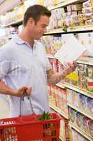 Man checking food labelling in supermarket