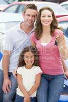 Young family collecting new car