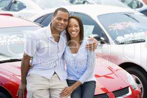 Couple looking at new cars