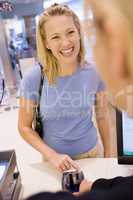 Woman entering security details for credit card purchase