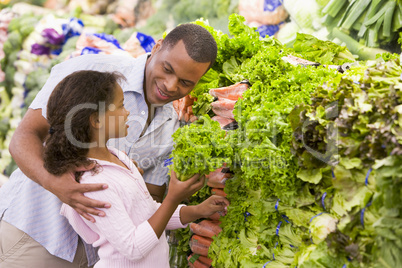 Father and daughter buying fresh produce