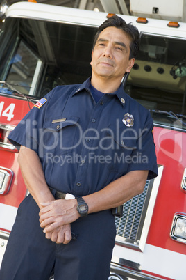 Portrait of a firefighter by a fire engine