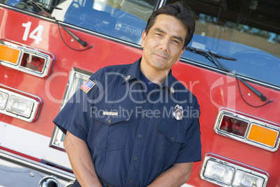 Portrait of a firefighter by a fire engine