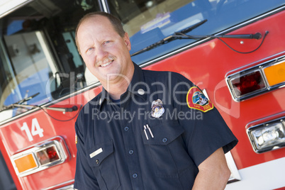 Portrait of a firefighter by a fire engine