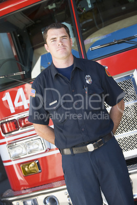 Portrait of a firefighter by a fire engine