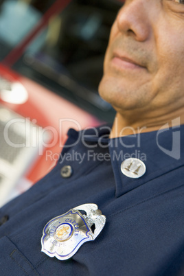 Portrait of a firefighter by a fire engine