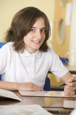 A schoolgirl studying in class