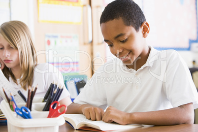 Schoolchildren reading books in class