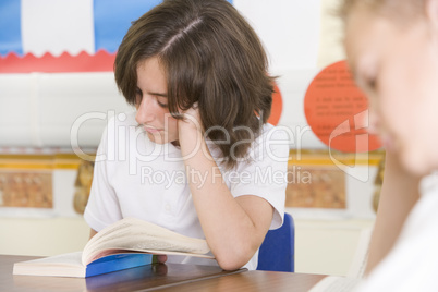 Schoolchildren reading books in class