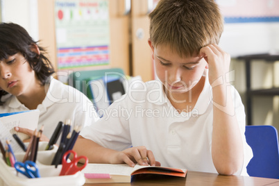 Schoolchildren reading books in class
