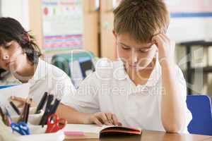Schoolchildren reading books in class