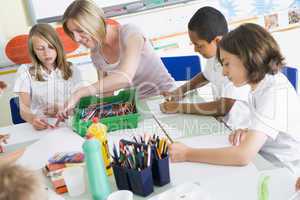 Schoolchildren and their teacher in an art class