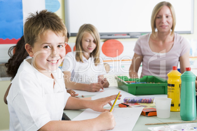 Schoolchildren and their teacher in an art class