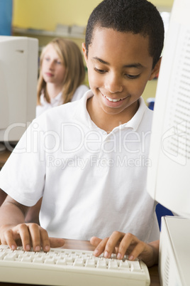 Schoolboy studying in front of a school computer