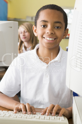 Schoolboy studying in front of a school computer