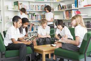 Junior school students working in a library