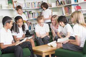 Junior school students working in a library