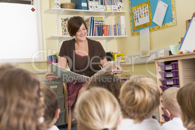 A teacher reads to schoolchildren in a primary class
