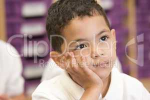 Schoolboy sitting in primary class