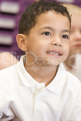 Schoolboy sitting in primary class