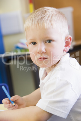 A schoolboy sitting in a primary class