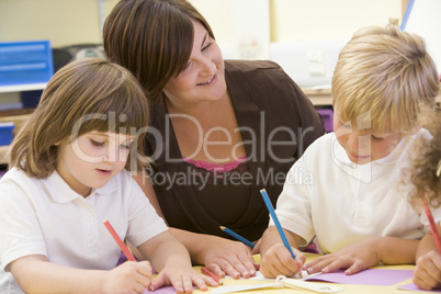 Schoolchildren and their teacher in a primary class