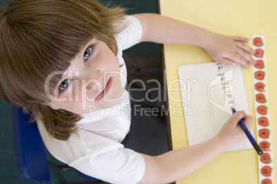 Girl learning to write numbers in primary class