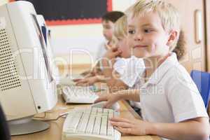 Boy working on a computer at primary school