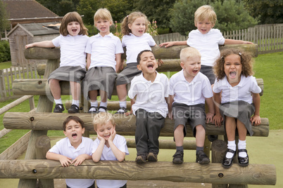 Young children sitting on benches and yelling