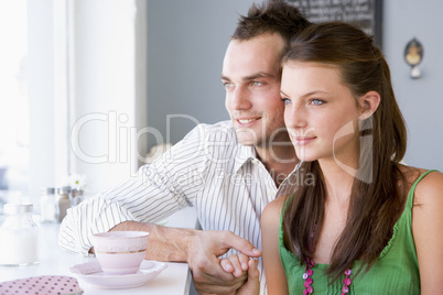 A young couple drinking tea in a cafe