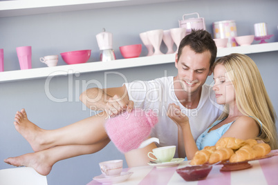 Flirtatious couple enjoying breakfast