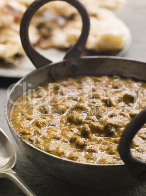 Kali Dahl Served in a Karahi With Naan Bread