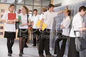 High school students by lockers in the school corridor