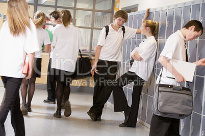High school students by lockers in the school corridor