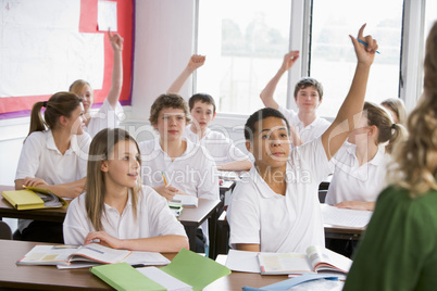 High school students answering a question in class