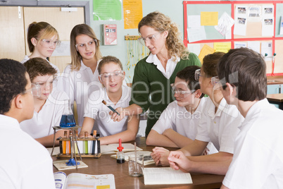 Schoolchildren and teacher in science class