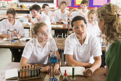 Schoolchildren and teacher in science class