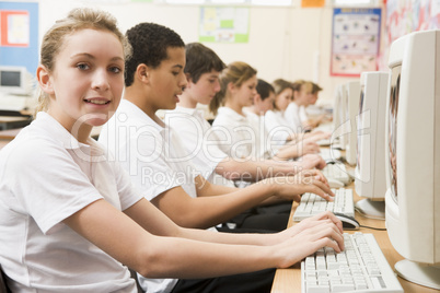 Row of schoolchildren studying in front of a computer