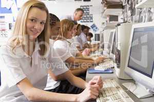 Row of schoolchildren studying in front of a computer