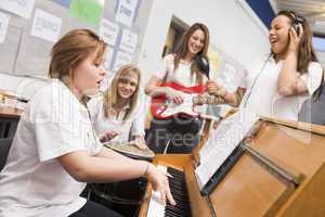 Schoolgirls playing musical instruments in music class