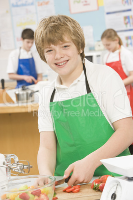 Schoolboy at school in a cooking class