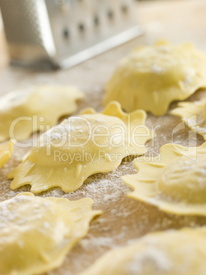 Uncooked Spinach and Ricotta Ravioli on a floured surface