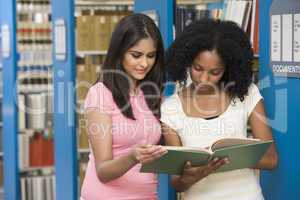 Two students working in university library